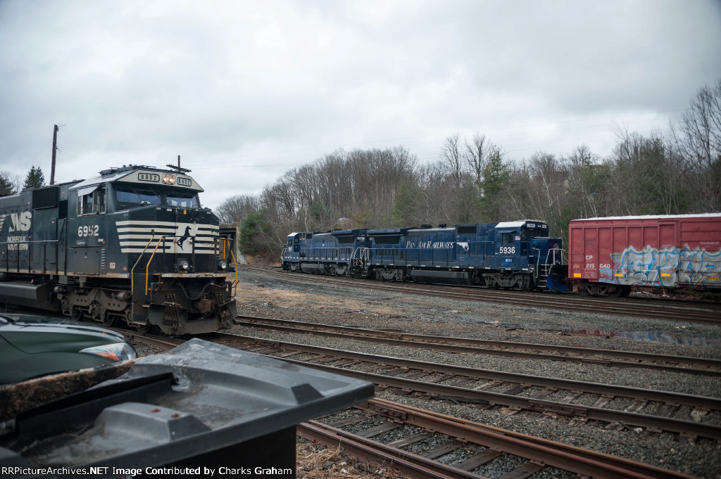 Parking boxcars backgrounds the mainline traffic